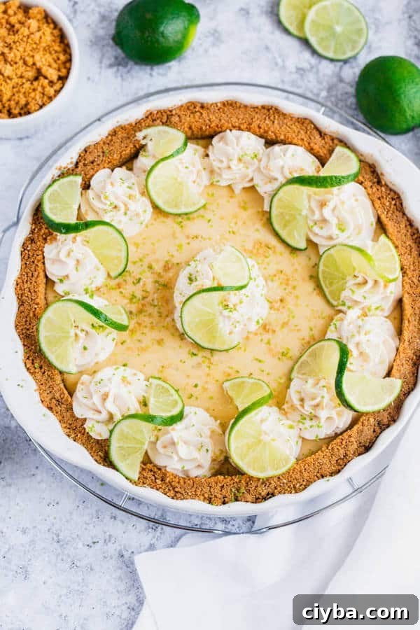 this key lime pie is made with a lime flavoured graham cracker crust, key lime pie filling and decorated with whipped cream, graham cracker crumbs, lime zest and lime twists