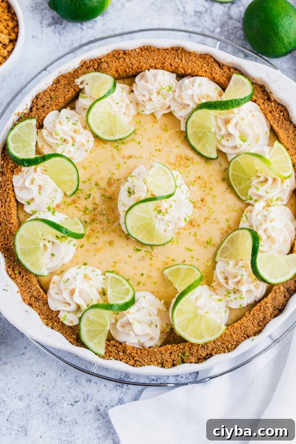 this key lime pie is made with a lime flavoured graham cracker crust, key lime pie filling and decorated with whipped cream, graham cracker crumbs, lime zest and lime twists