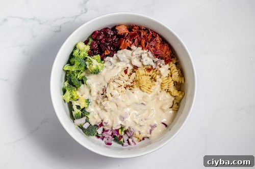 dressing drizzled over broccoli pasta salad