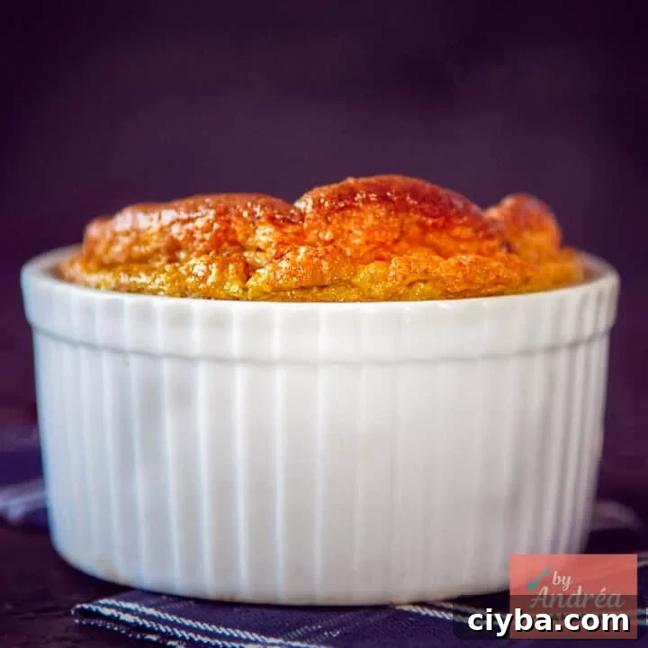 A square photo of a ramekin with a Jerusalem artichoke soufflé that has risen to the top.