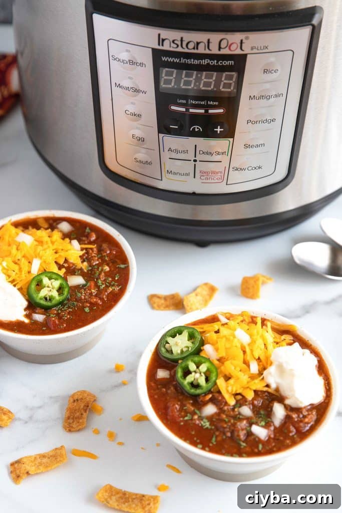 Instant Pot Texas Chili Recipe — Ready in 30 Minutes 3 Bowls of chili sitting next to an Instant Pot pressure cooker.