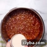 Instant Pot Texas Chili Recipe — Ready in 30 Minutes 22 pouring masa harina and water over the chili