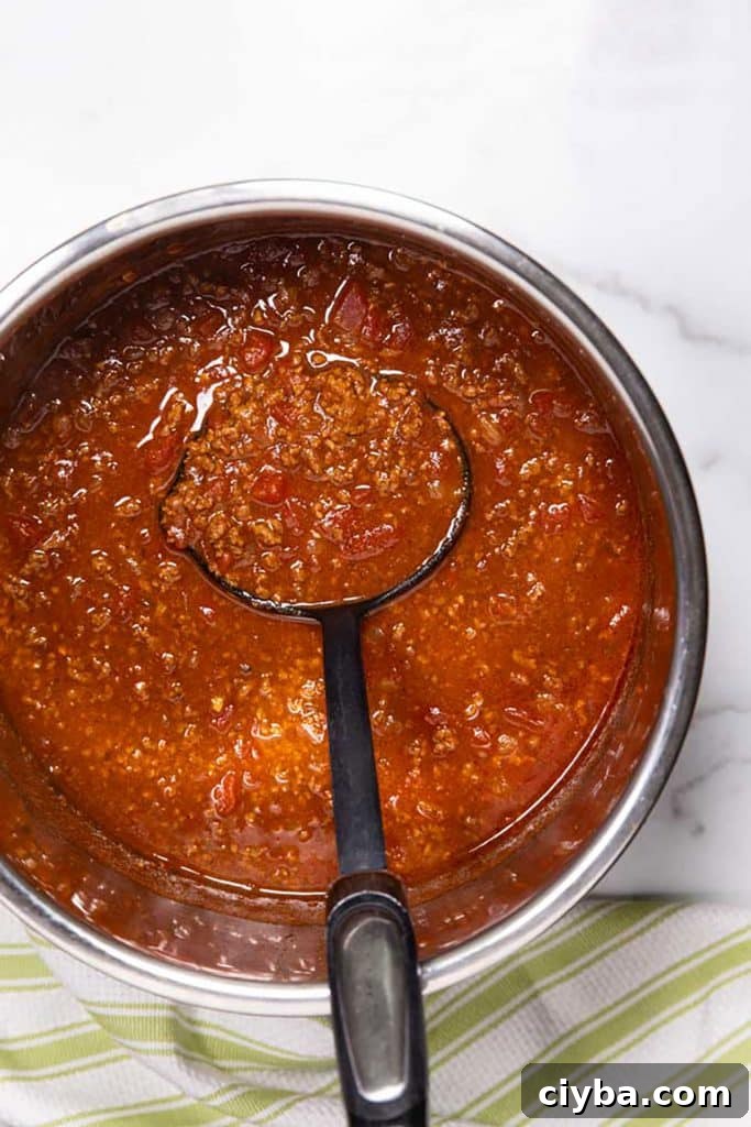 Instant Pot Texas Chili Recipe — Ready in 30 Minutes 10 scooping texas chili from an instant pot