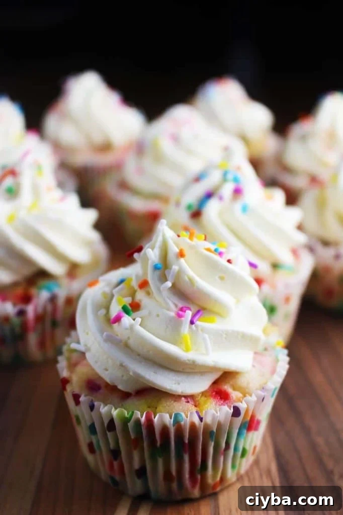 Homemade funfetti cupcakes with vanilla frosting and sprinkles