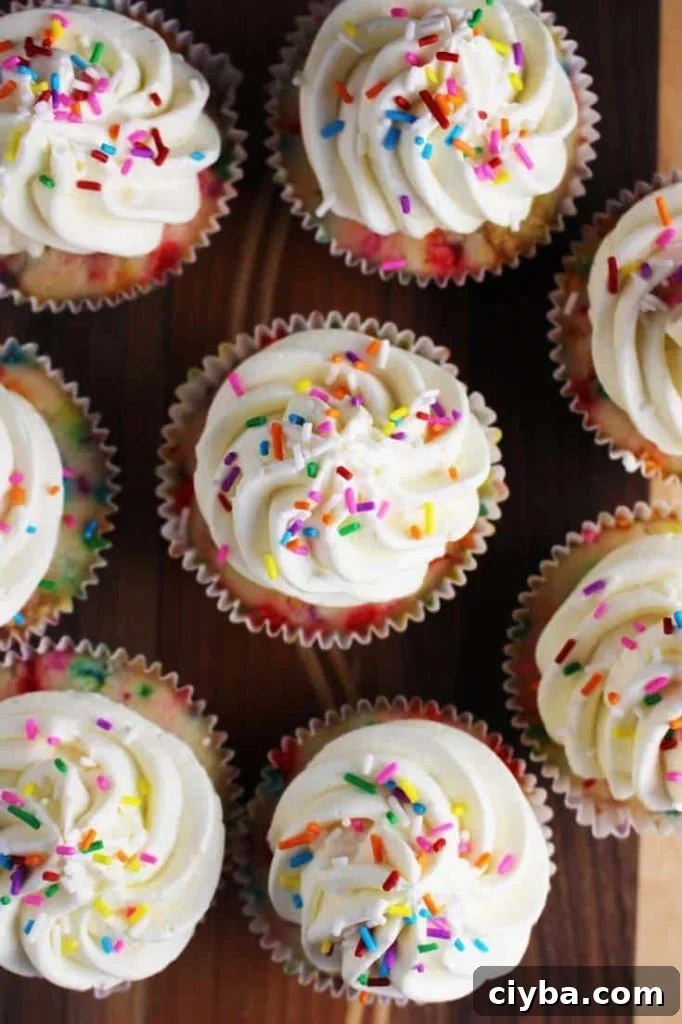 Top view of homemade funfetti cupakes with vanilla frosting and sprinkles