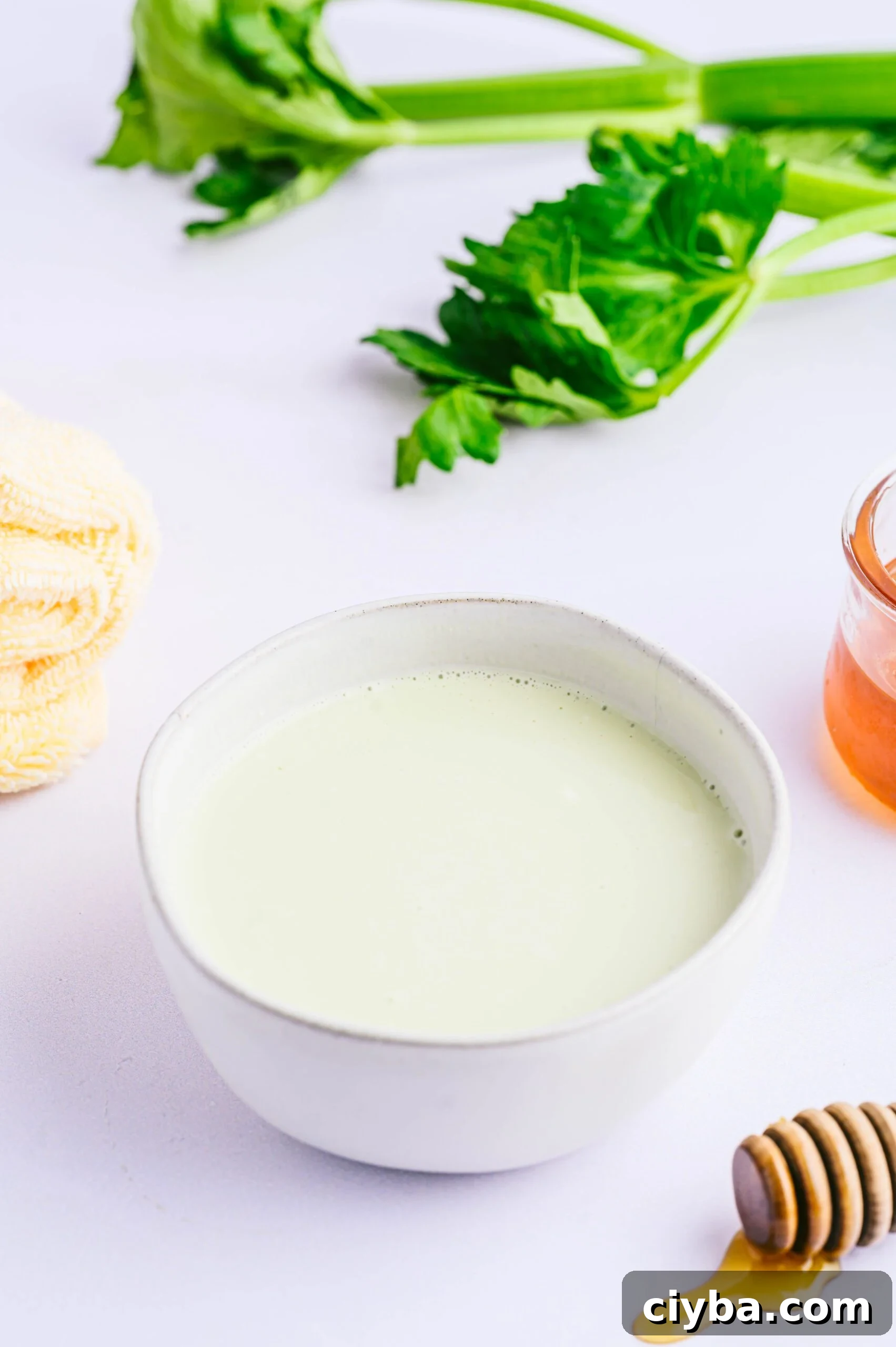 Revitalize Hair with a Homemade Celery Mask for Shine and Growth 3 Celery Hair Mask in bowl surrounded by towel and ingredients