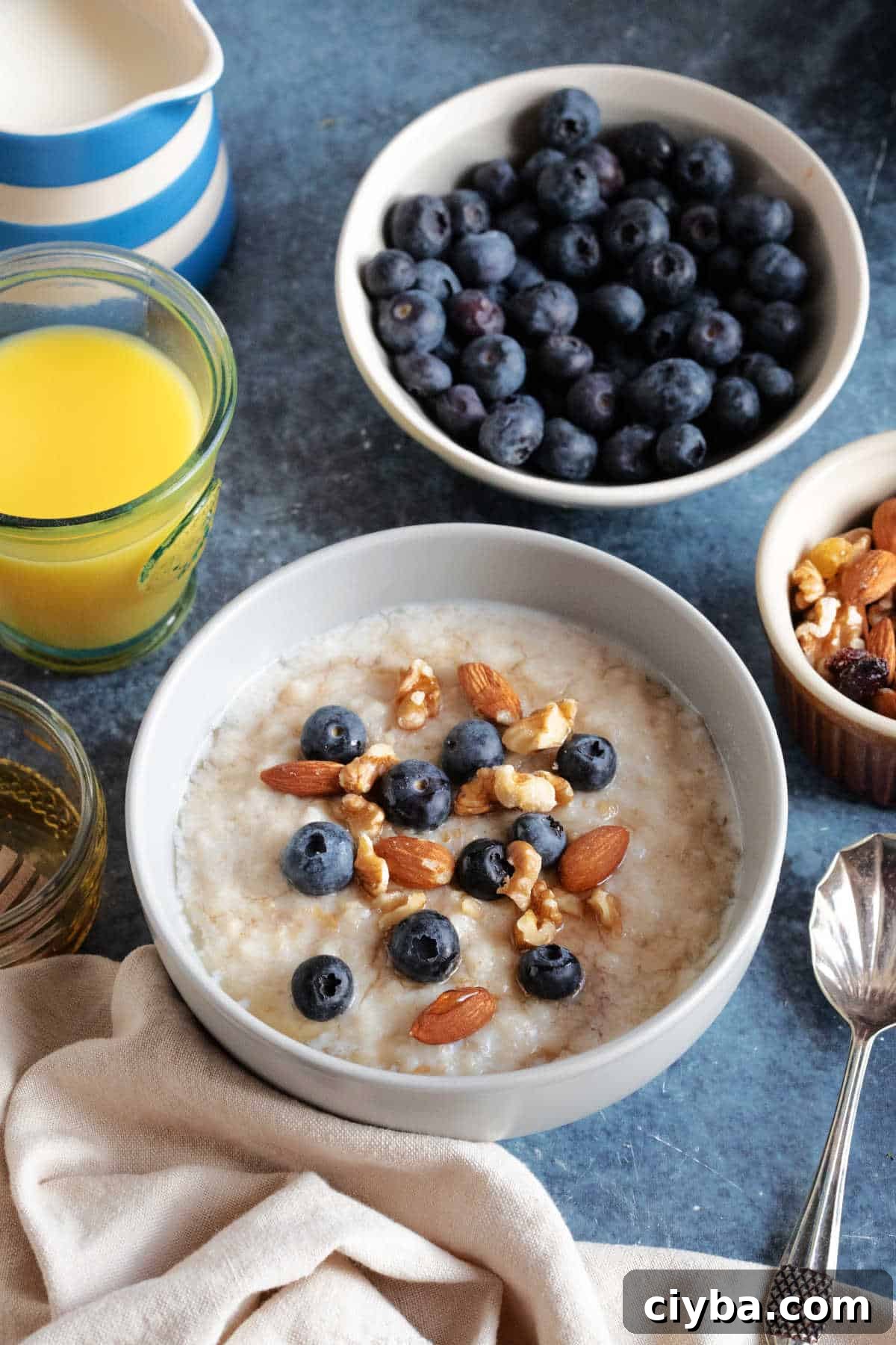 A bowl of slow cooker porridge with blueberries, nuts and honey.