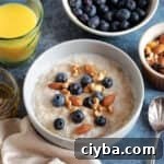 A bowl of slow cooker porridge with blueberries.