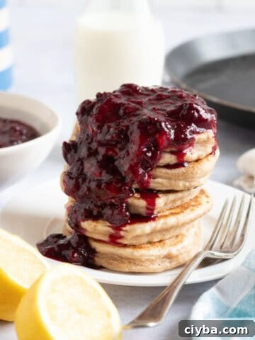 Frozen berry compote spooned over pancakes.