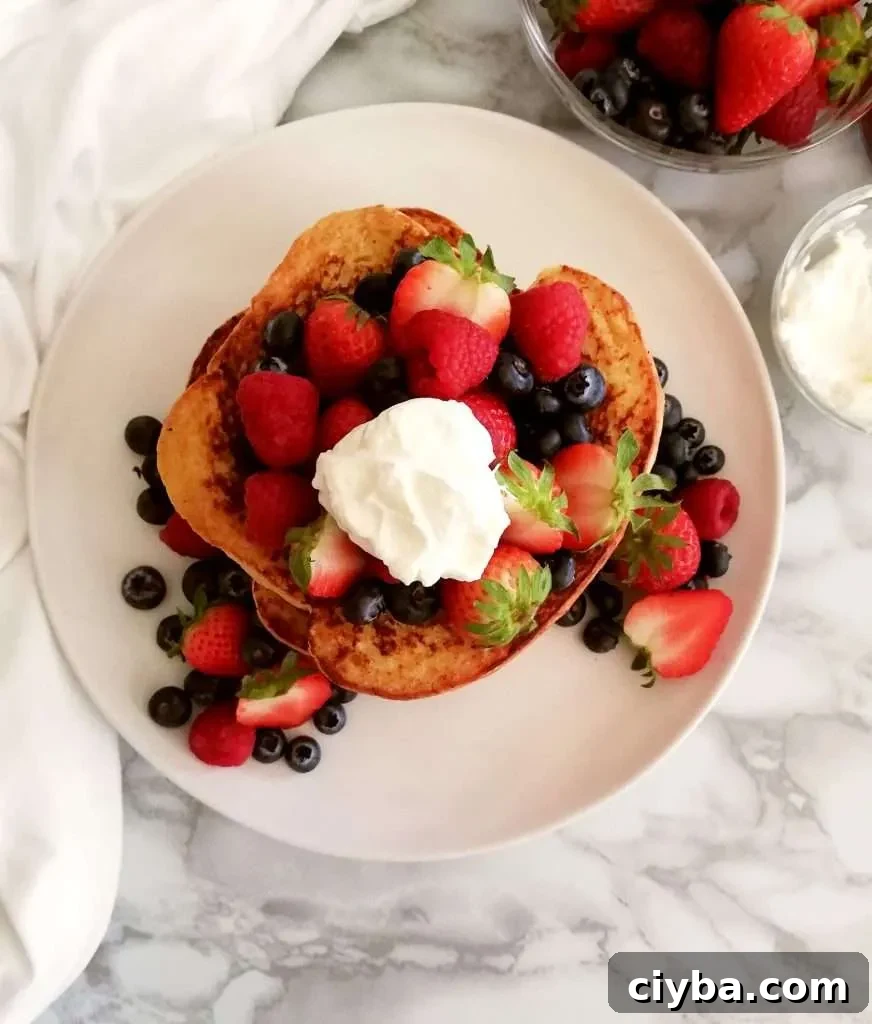 French toast topped with berries and whipped cream overhead