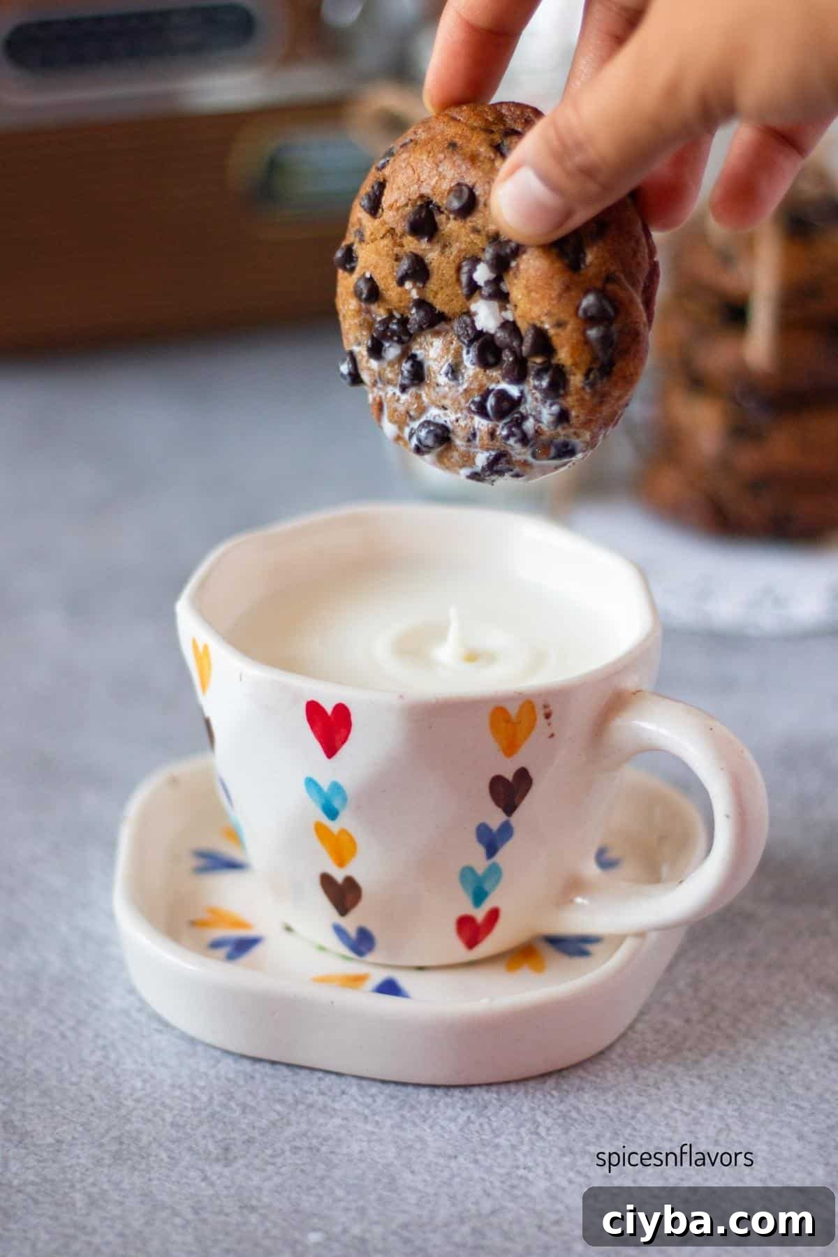 dipping brown butter sourdough chocolate chip cookie in milk