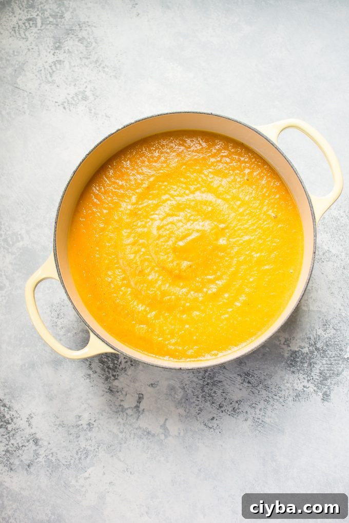 pot filled with acorn squash carrot soup
