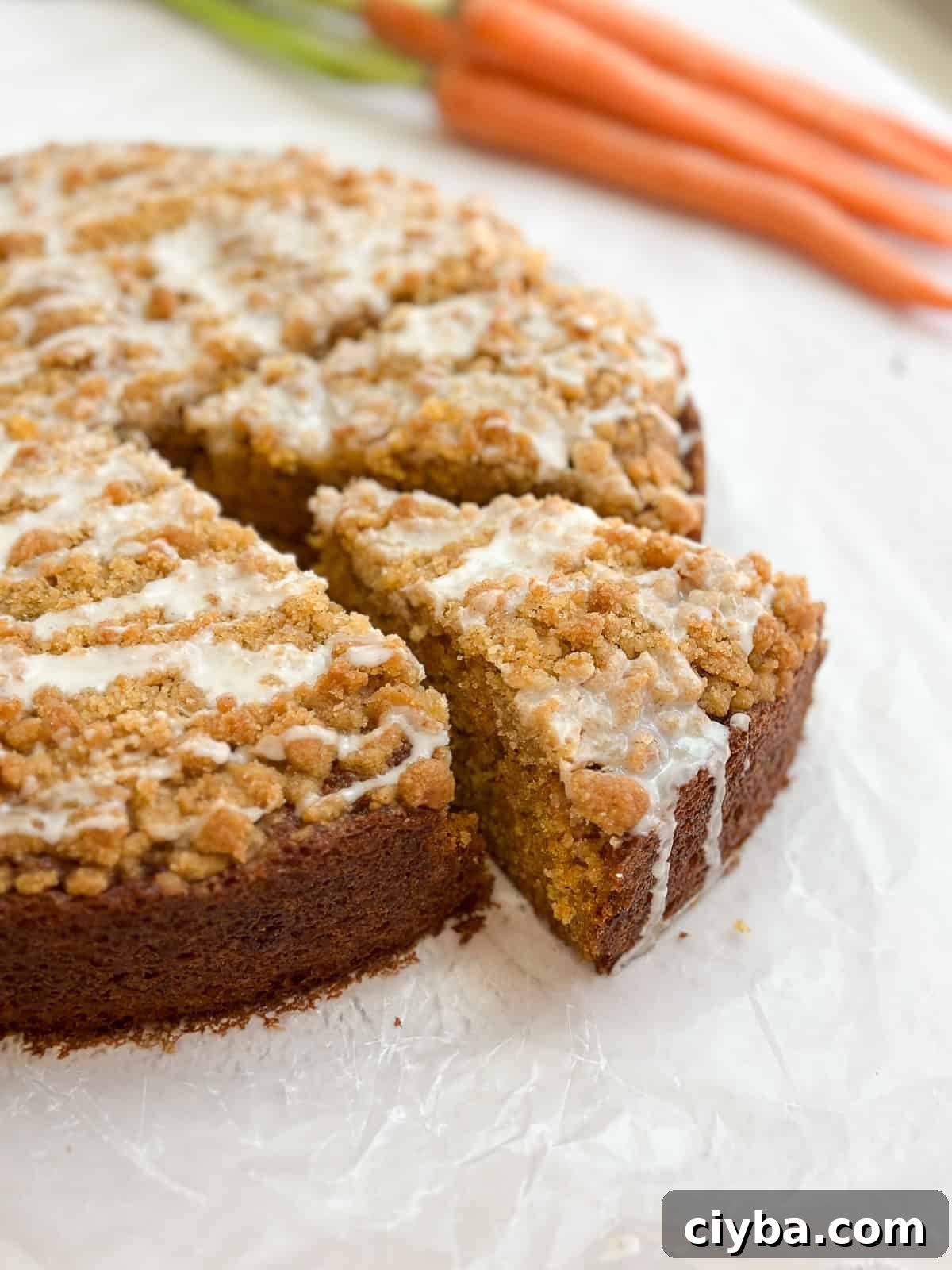 a piece of carrot cake coffee cake coming out from the whole cake.