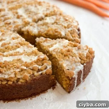 a piece of carrot cake coffee cake coming out from the whole cake.