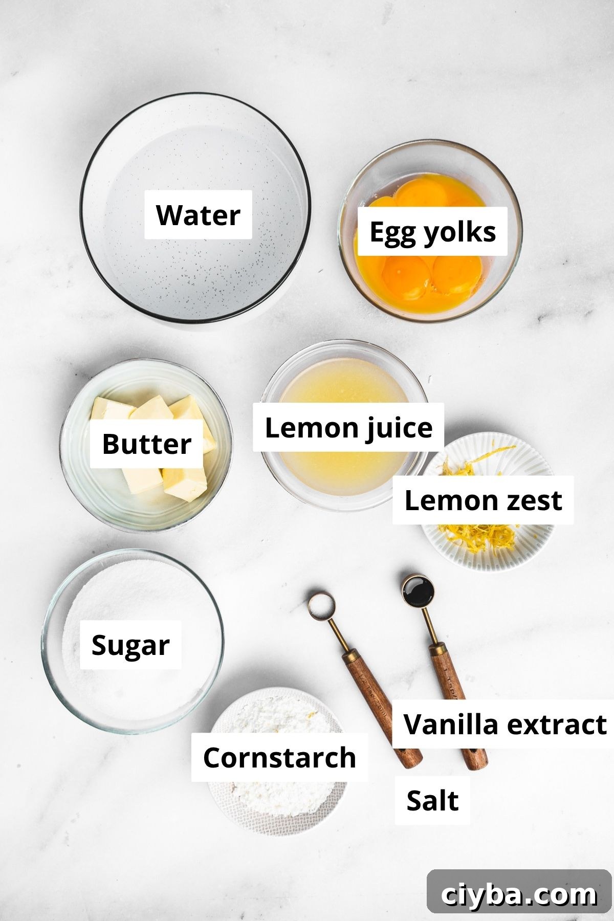 ingredients for lemon meringue pie filling in bowls on a kitchen counter