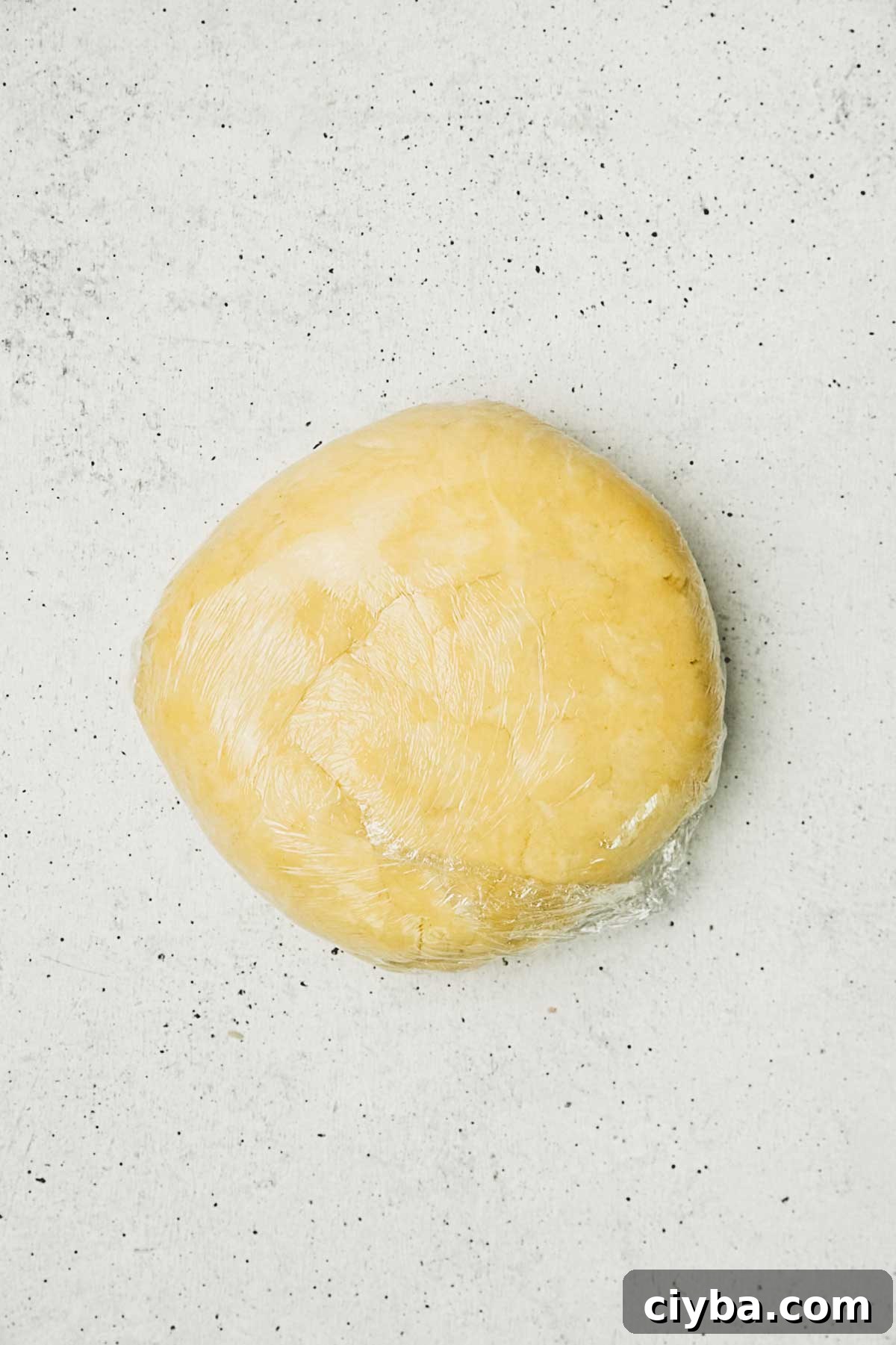 homemade pie dough wrapped in plastic wrap for lemon meringue pie
