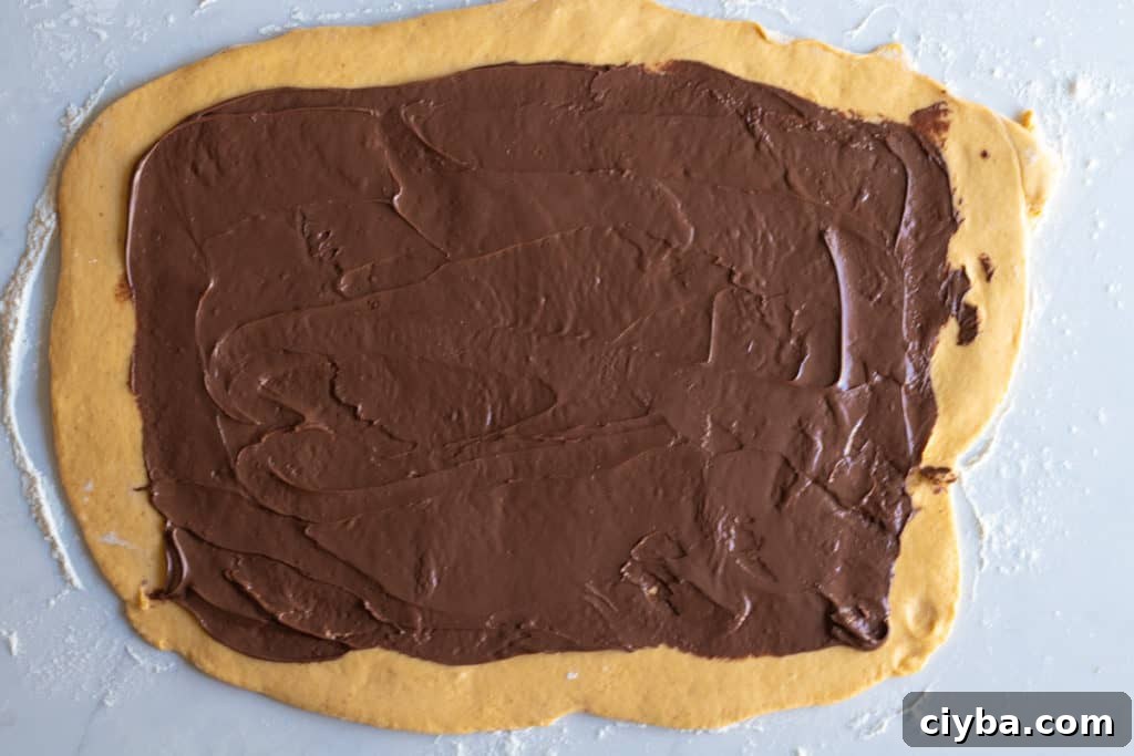 pumpkin babka dough rolled into rectangle and spread with nutella