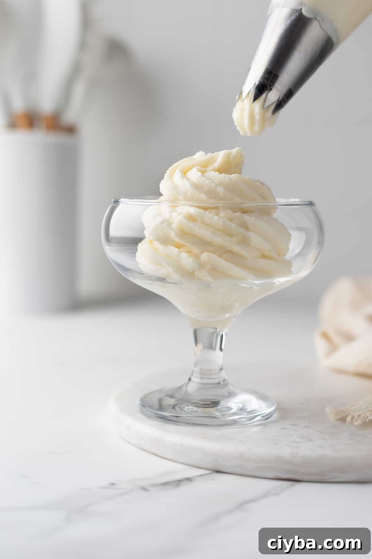Diplomat Cream Recipe: Smooth Creme Diplomate for Pastries 5 Creme Diplomate piped into a glass with a pastry tip on top