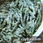 Roasted frozen green beans in dish.