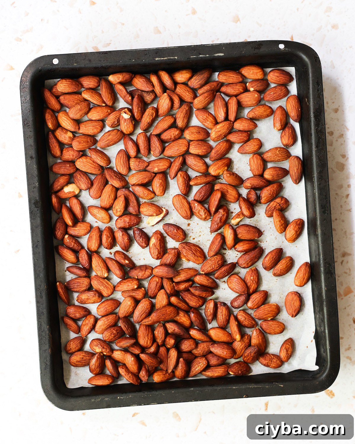 An overhead shot of a pan of roasted tamari almonds.