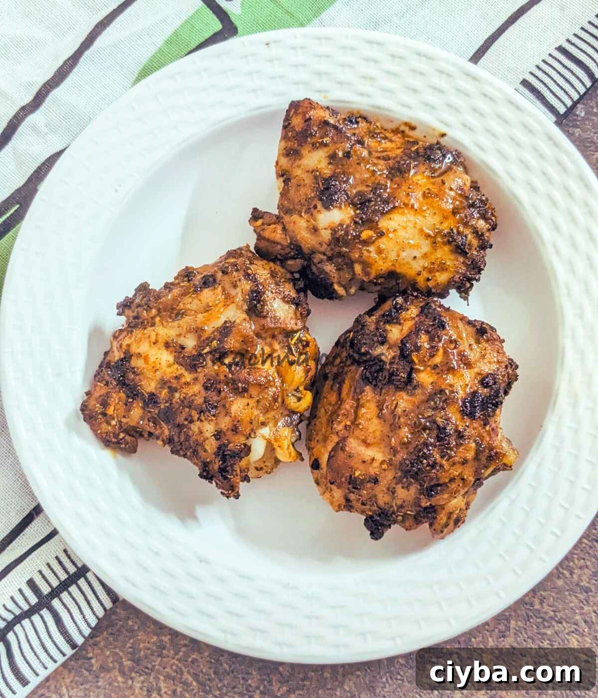 3 chicken thighs served on a plate