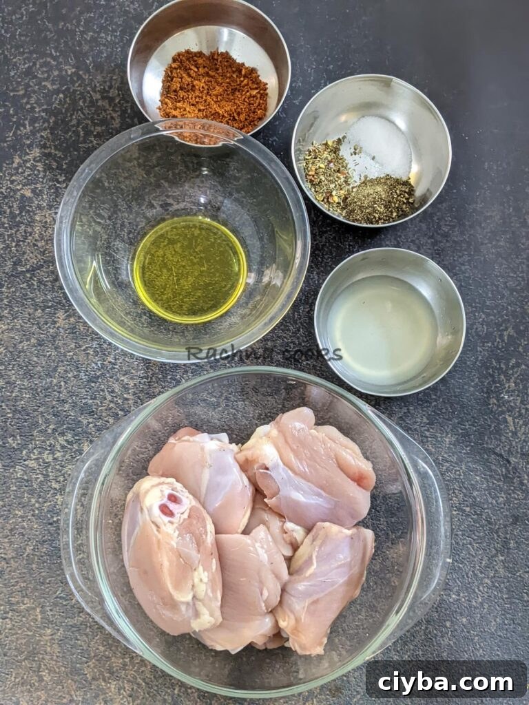 In bowls, skinless chicken thighs, olive oil, lemon juice, Italian seasoning, pepper, salt, paprika, onion powder and garlic powder.