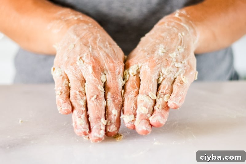 Massaging the hand mask into the hands.