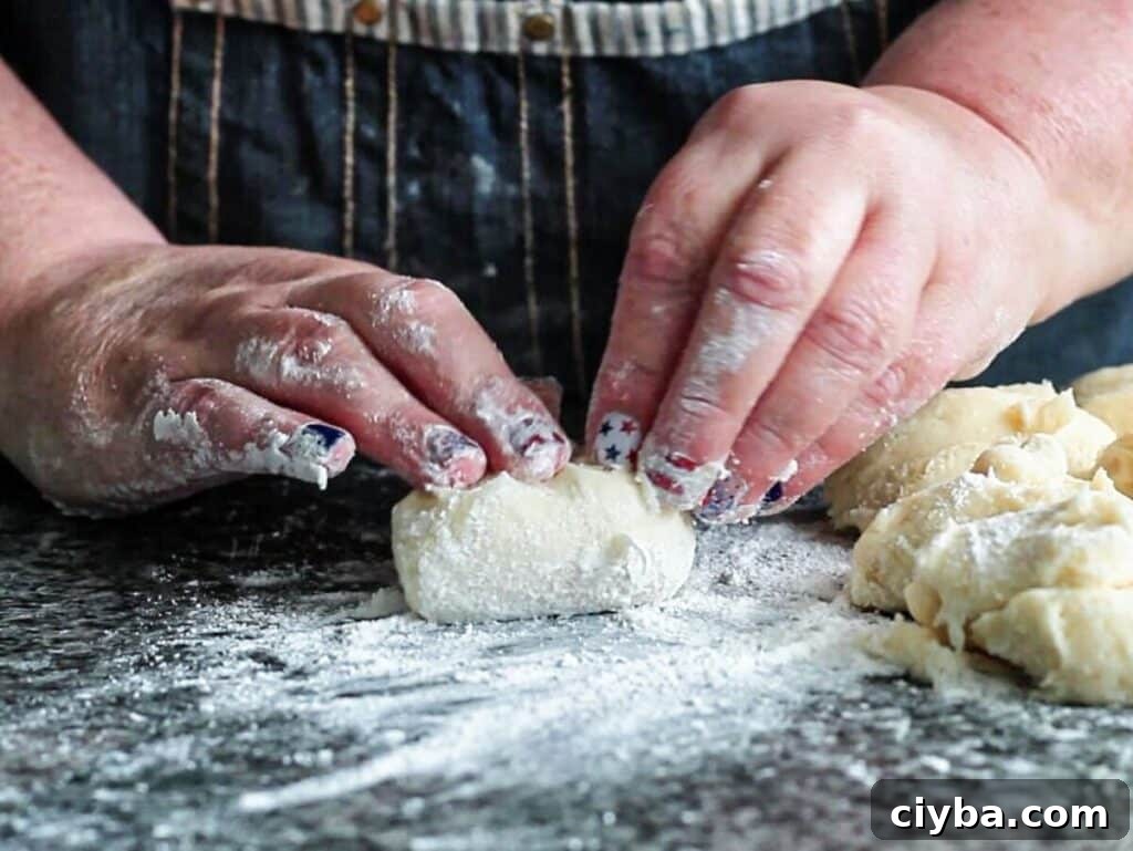 folding dough into center to create a tight ball.  