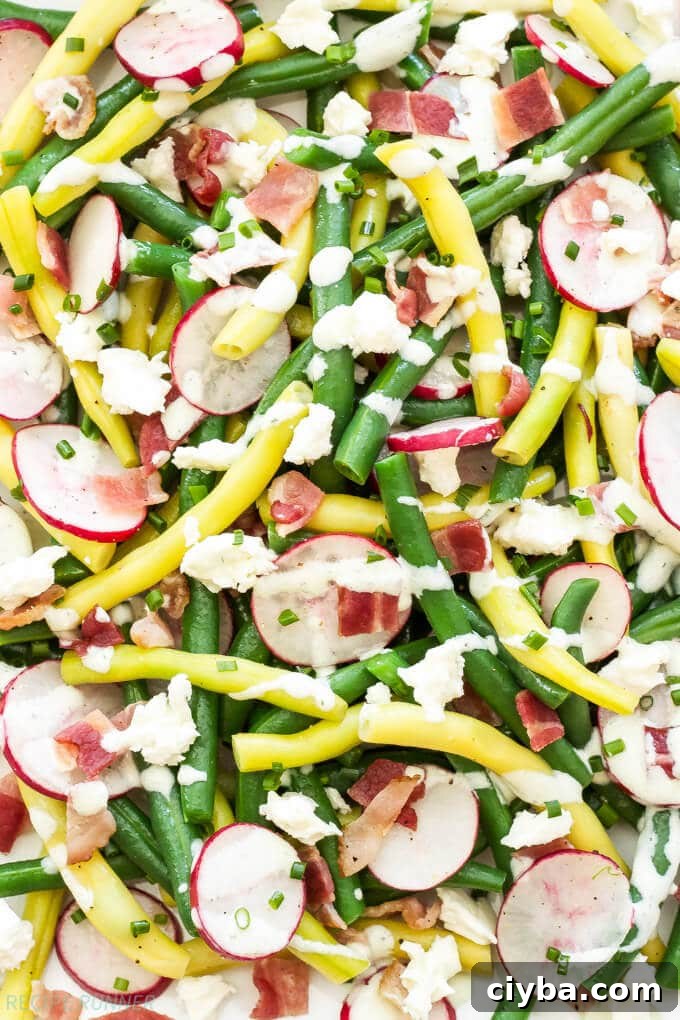 green beans, radishes, bacon and creamy feta dressing on a plate