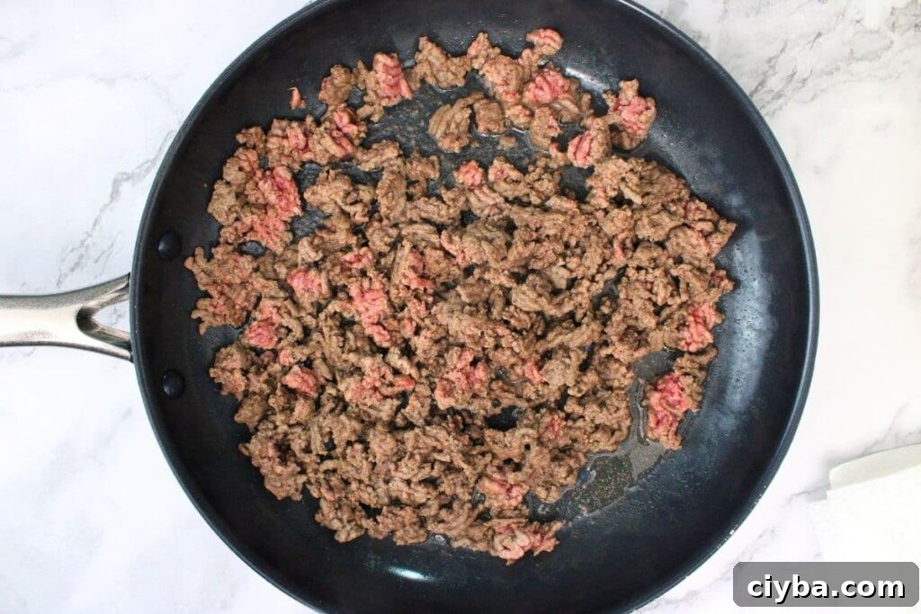 partially brown ground beef in skillet