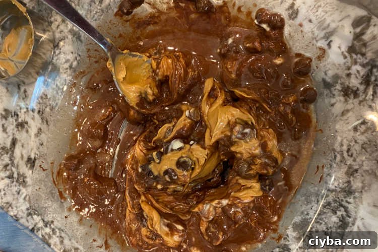 melted peanut butter and chocolate chips in a mixing bowl