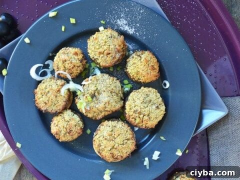 Mushrooms stuffed with couscous on a navy plate on a purple tray