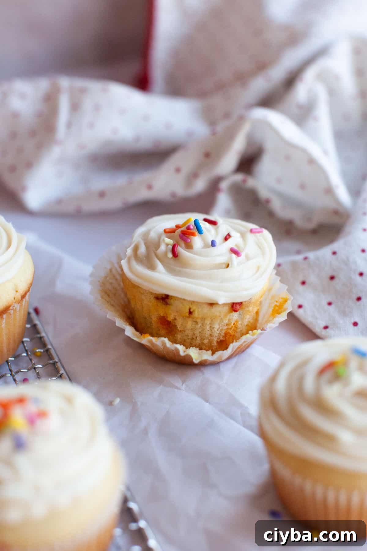 a colorful vanilla cupcake with vanilla buttercream frosting.
