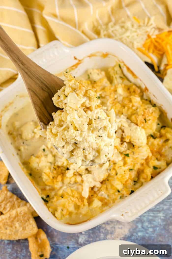 wooden spoon with part of keto cauliflower mac and cheese on it