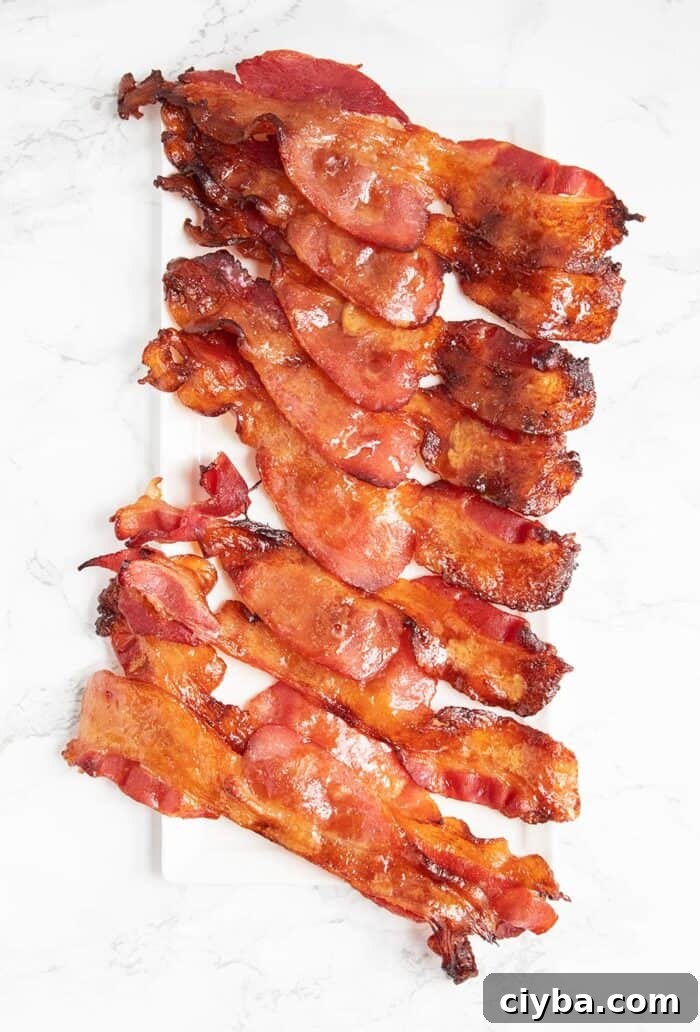 keto candied bacon laid down on a white plate in strips