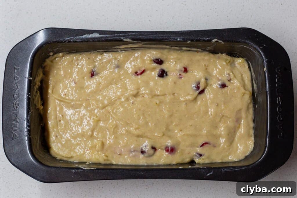 Loaf pan with batter for Cranberry Banana Bread.