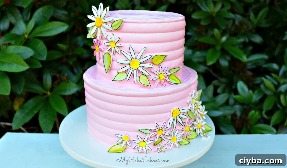Closeup of painted fondant daisies on cake
