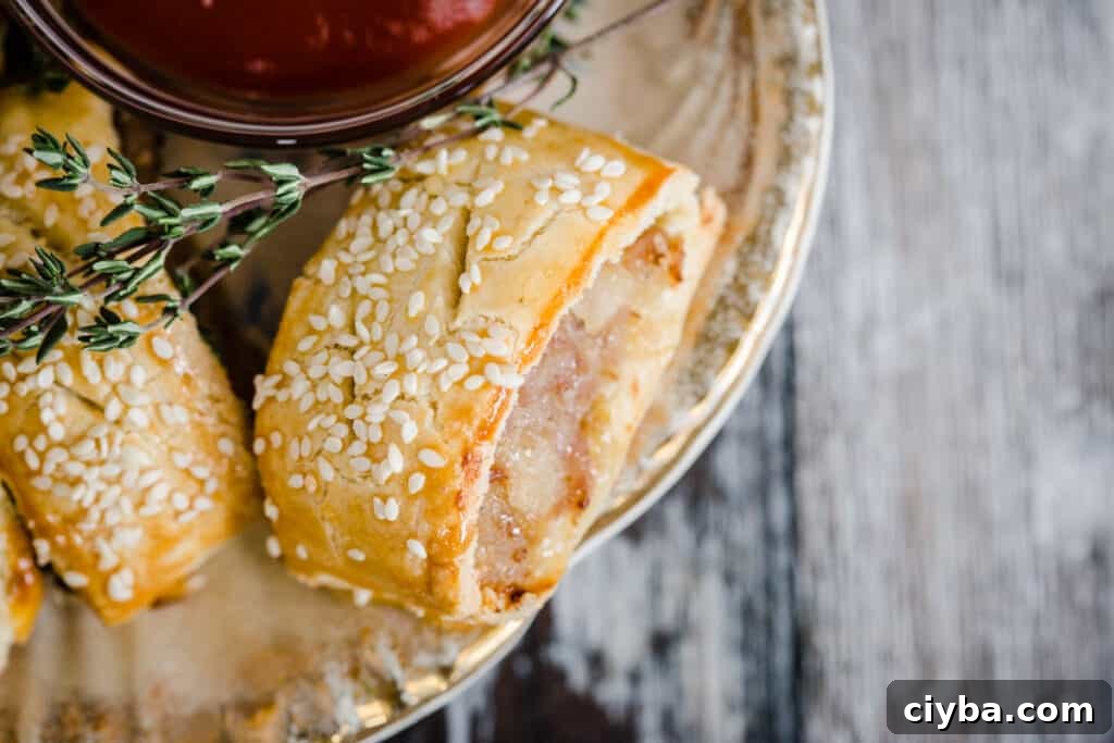 Gluten-Free Sausage Rolls with Homemade Pastry Recipe 17 sausage roll on a plate with a bowl of ketchup