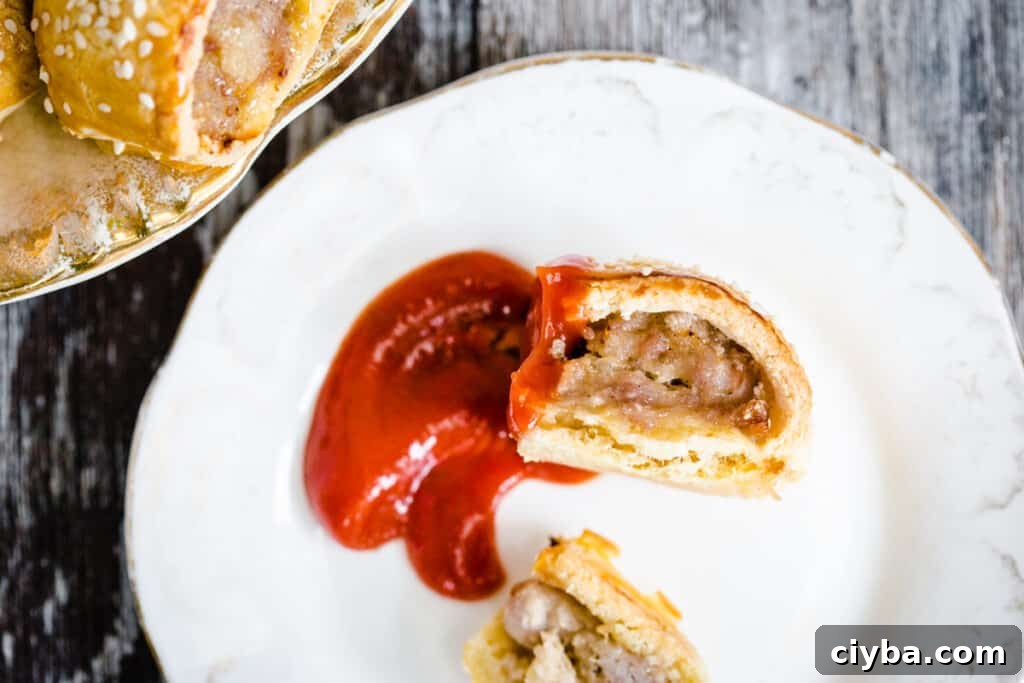 Gluten-Free Sausage Rolls with Homemade Pastry Recipe 18 Sausage roll dipped in ketchup on a plate