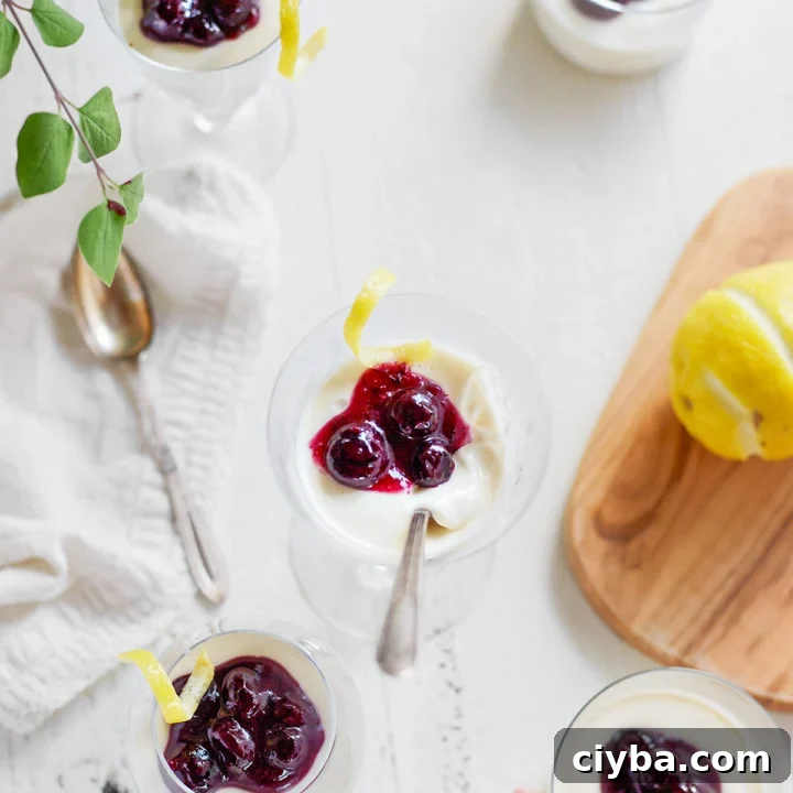dessert glasses filled with lemon panna cotta and topped with blueberries
