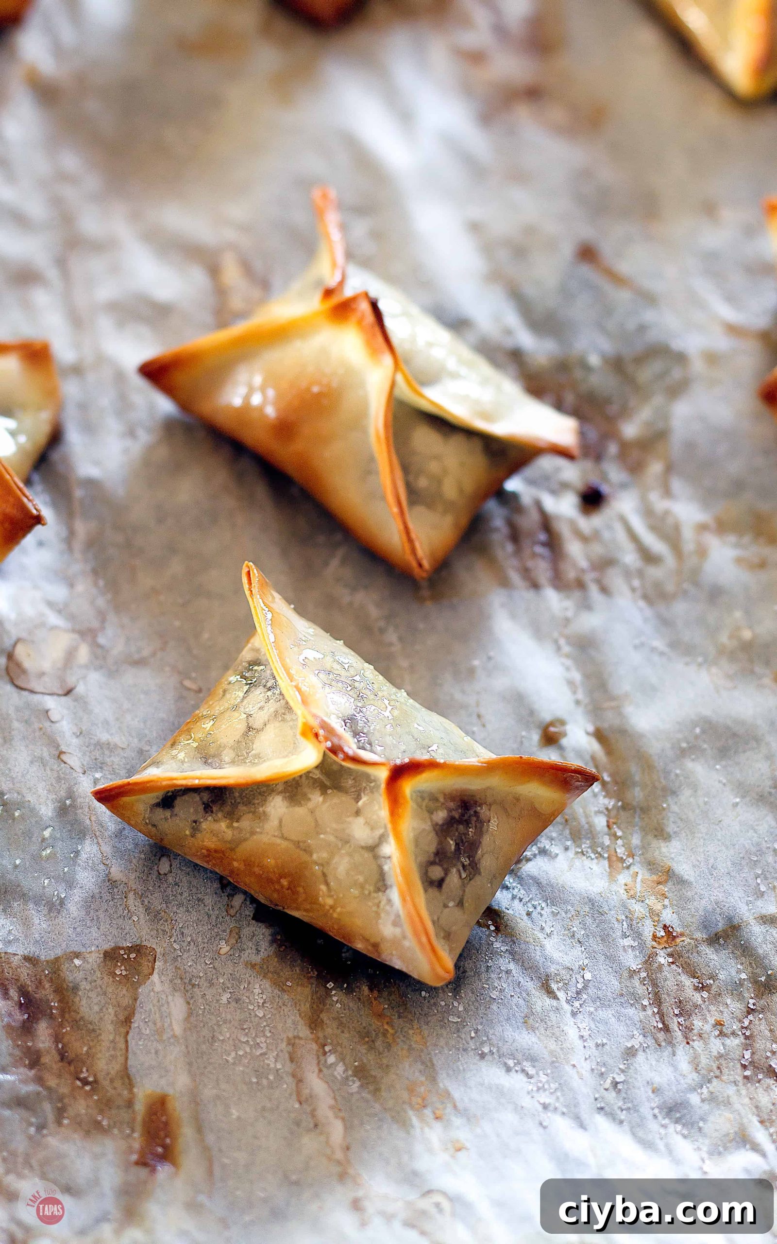 Turtle Wonton Kisses: Chocolate-Peanut Butter Candy Recipe 7 wonton on parchment paper just out of the oven