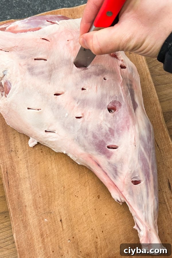 leg of lamb pierced with a knife