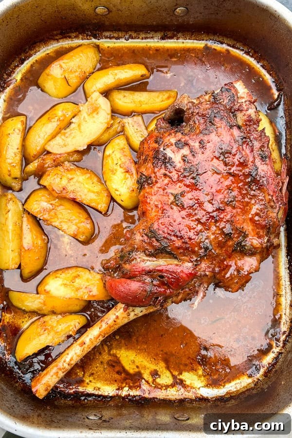 Greek Slow Roast Leg of Lamb with Potatoes in a tray