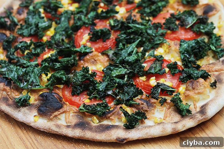 Grilled kale pizza with smoked Gruyère, sweet corn and chili oil