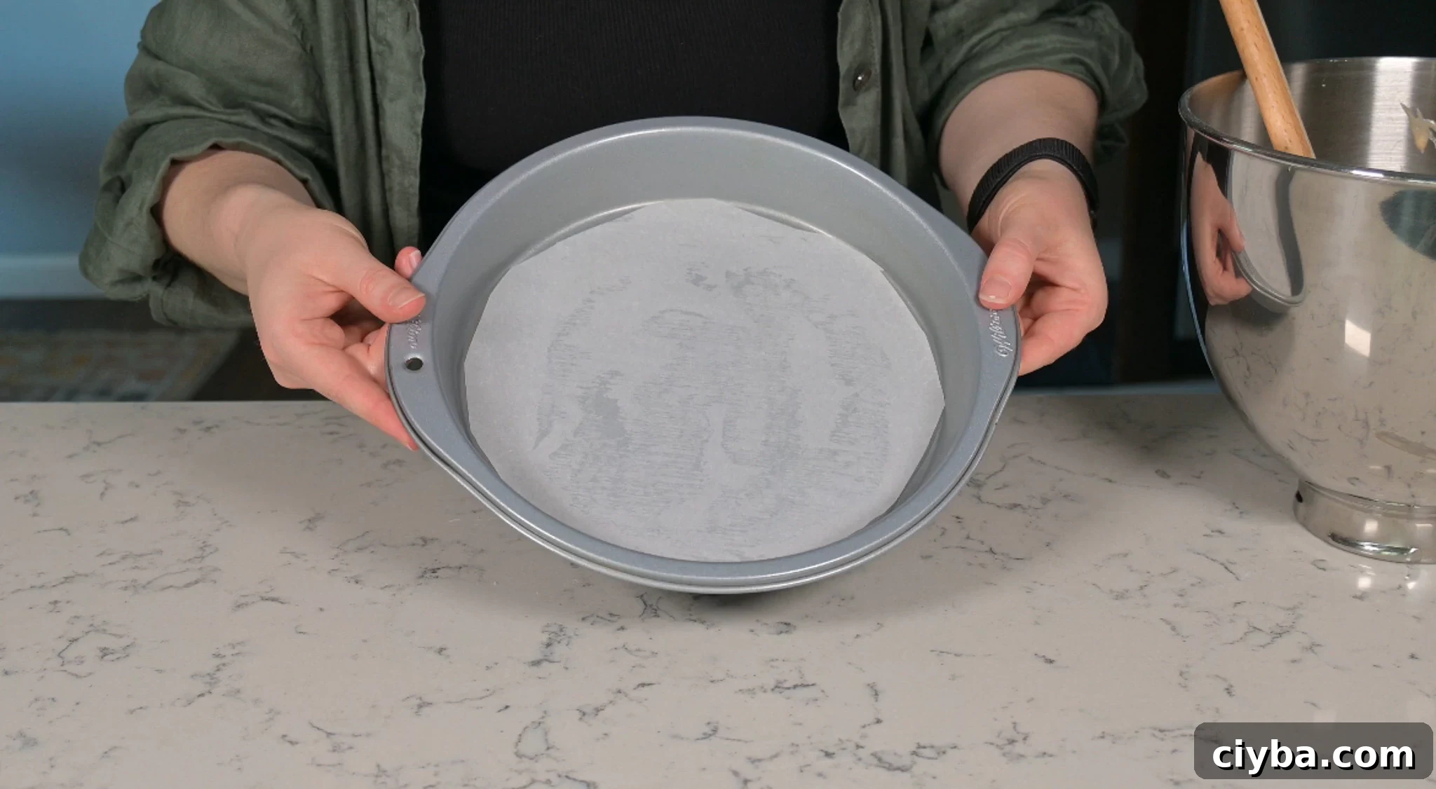 Lining a baking tin with parchment paper.