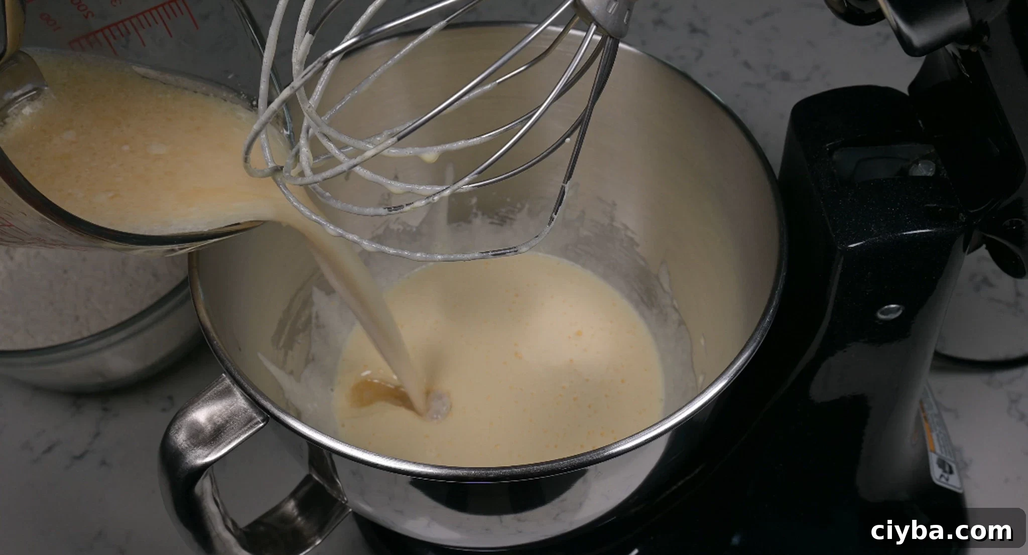 Adding in wet ingredients to the batter.