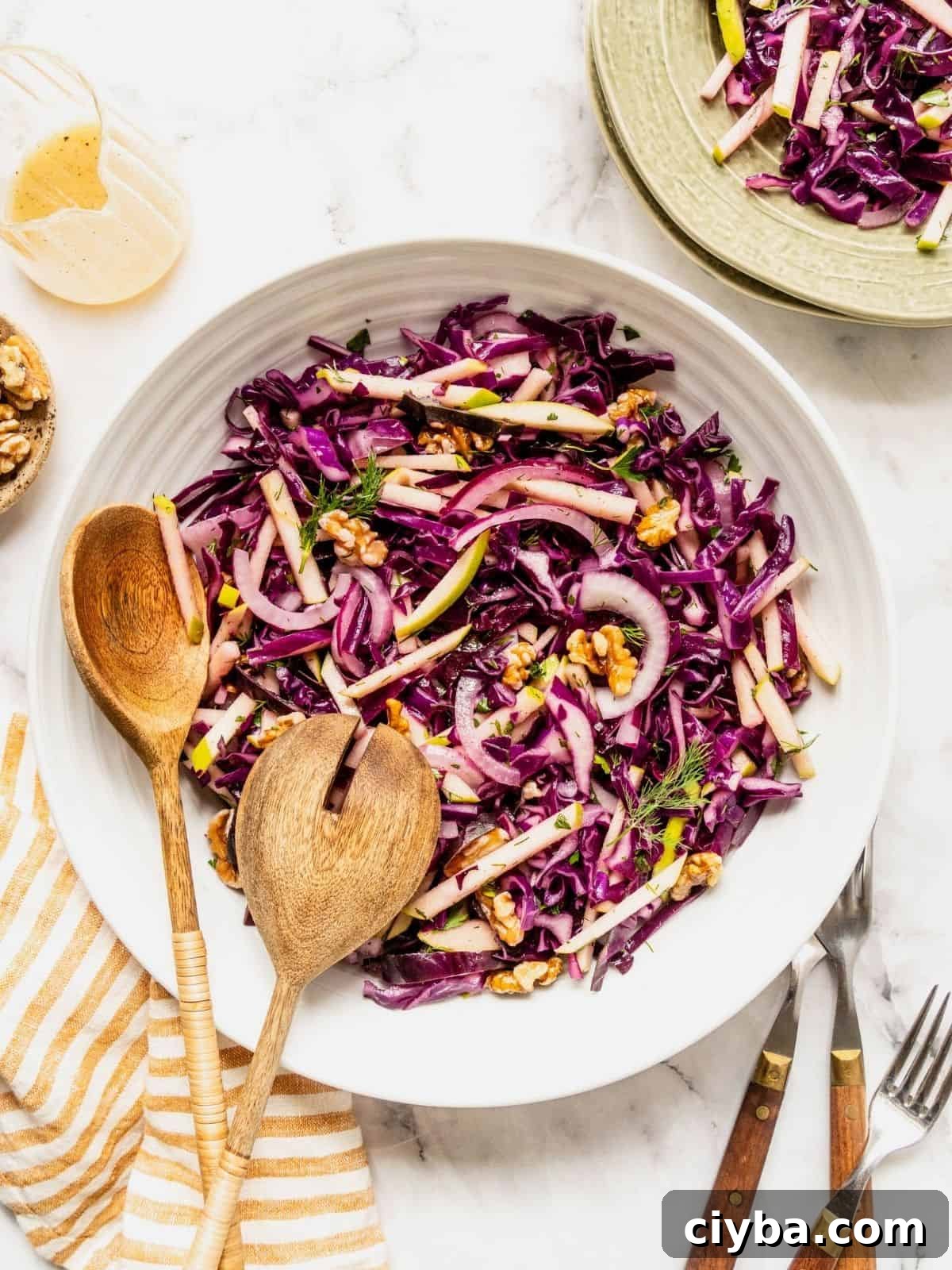 Crisp Purple Cabbage Slaw with Apple and Walnut Crunch 2 Purple cabbage slaw with apples and walnuts in a bowl.