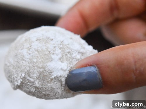 How to make Italian Wedding Cookies, rolling cookies on confectioner's sugar