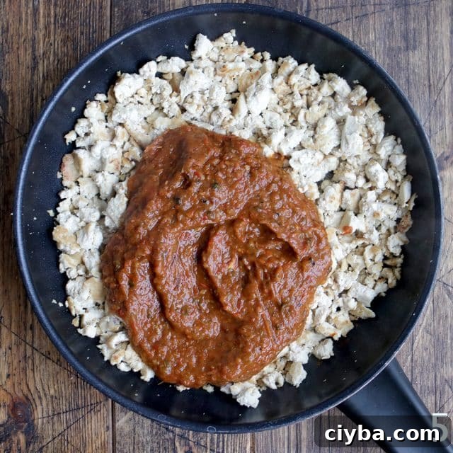 Chipotle-Style Sofritas Recipe: Spicy Tofu Bowl in 30 Minutes 10 Crumbled tofu with sauce on a pan