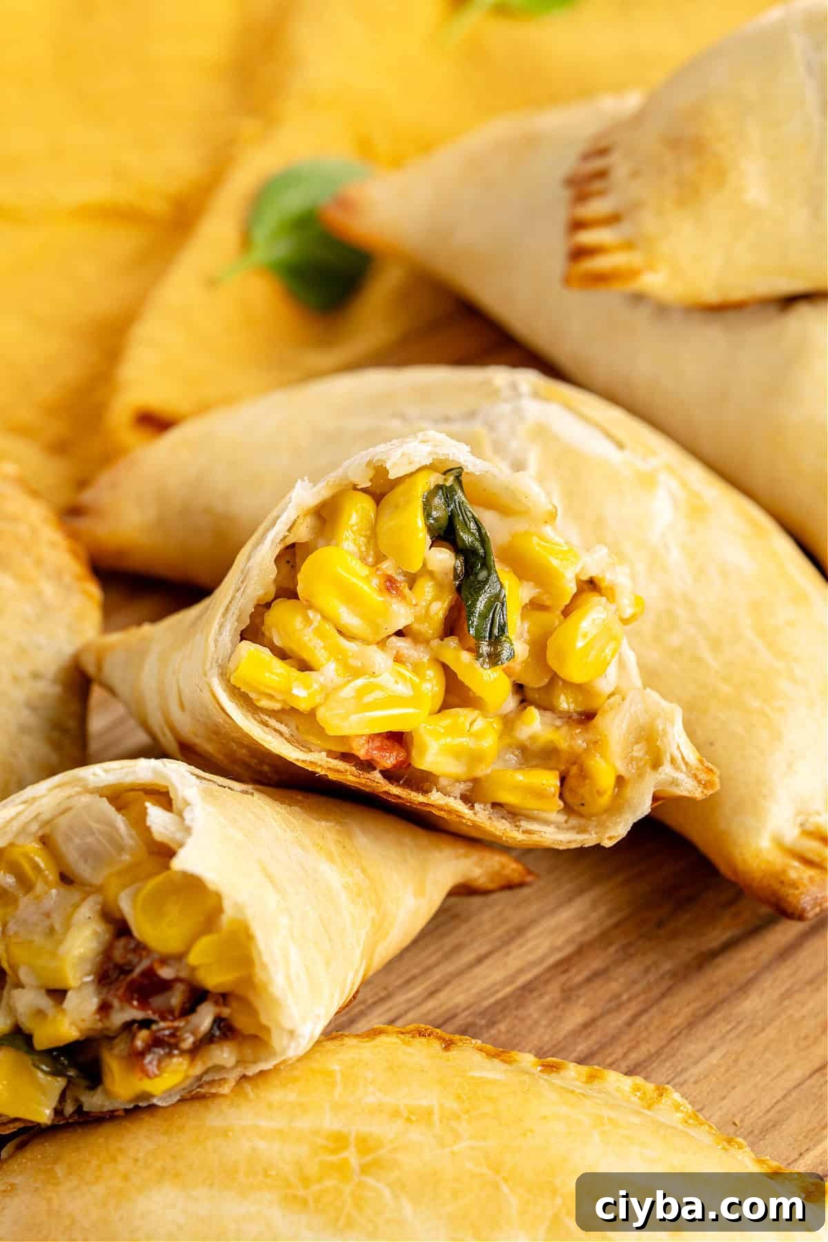 Halved corn empanada with whole ones.